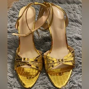 Metallic gold and glitter high heeled sandals.
